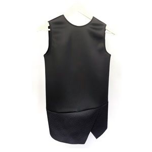 Neil Barrett structural/ asymmetrical woman’s black top. Sleek, vividly black.
